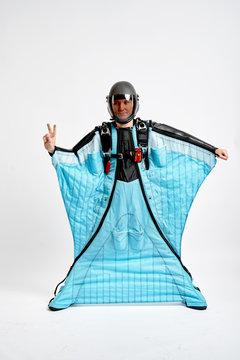 Two fingers. Men in wing suit show two fingers. Skydiving men in parashute. Simulator of free fall.