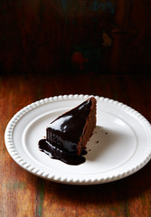Piece of chocolate cake on dark background. 