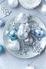 Christmas ornaments on bright wooden background. Top view. 