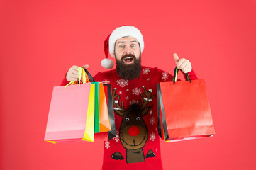 Delivering your purchase. Shopping with pleasure. Man bearded hipster wear winter sweater hold shopping bags. Buy new year gifts. Shopping for presents. Nice purchase. Discount for club members