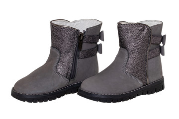 Winter boots. Close-up of a single elegant gray silver leather winter boot lined with white leather. Girls winter shoe fashion new trends isolated on a white background. Macro photograph.