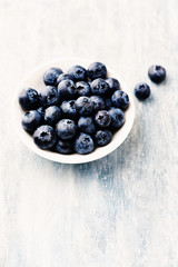 Bilberries on bright wooden background. Concept for healthy nutrition. Close up. 