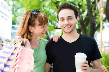 Couple with shopping bags walking on the streets.