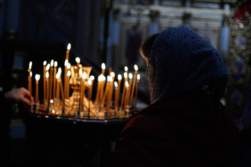 person in front of candles in a church