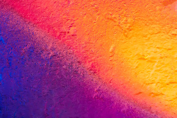 Beautiful bright colorful street art graffiti background. Abstract creative spray drawing fashion colors on the walls of the city. Urban Culture,  red , crimson , yellow, green, blue, purple texture