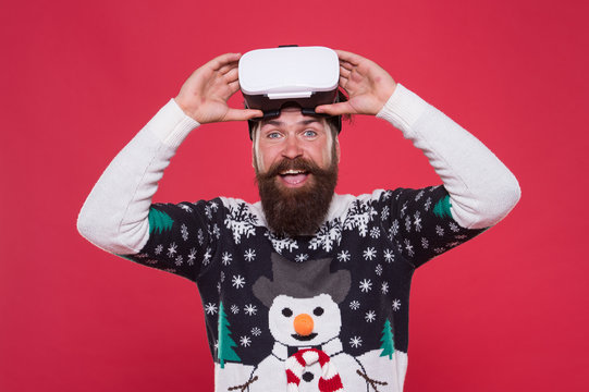 man winter sweater play game. indoor vs outdoor activity. Virtual reality. man wearing virtual reality goggles. xmas party. happy bearded hipster in vr glasses. interacting with a virtual environmen