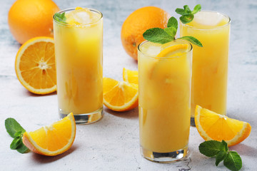 Glasses full of orange juice with ice	