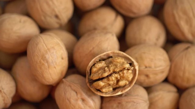 Walnut close up. product rich in minerals and vitamins. Walnut turns in a shot. Walnut kernels rotating. walnut close up lies under beams of the sun. Macro