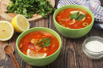 Two bowls with traditional Russian soup solyanka