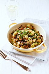 Gnocchi with champignon mushrooms and onion on bright background. 