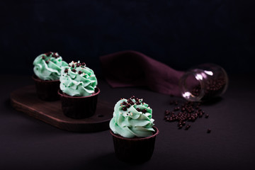 cupcakes and sprinkles on a dark background