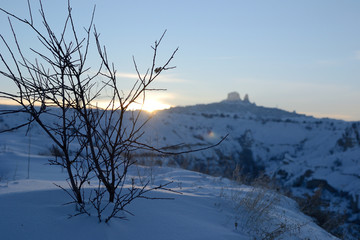 Fototapeta na wymiar Winter snowy sunset view of Cappadocia in Goreme, beautiful rock formations