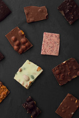 Сhocolate plates flat lay view on dark background, top of view