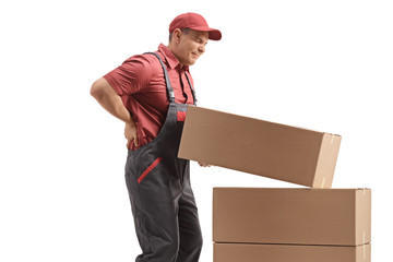 Male worker lifting a package and holding his painful back