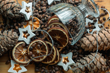 Christmas still life of citrus, pine cones and nuts, with garlands.