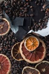 brown background of chocolate, nuts and dried citrus