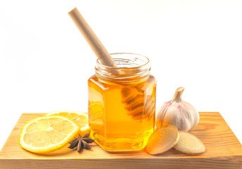 Honey and garlic with ginger, nuts on a white background
