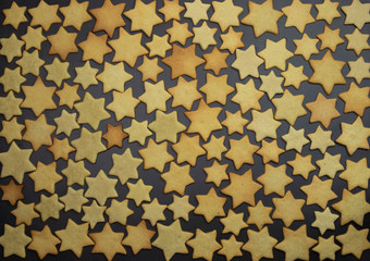  Cookies in the form of a star of Bethlehem are on a black background.