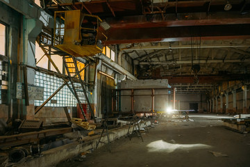 Old broken empty abandoned industrial building interior at night