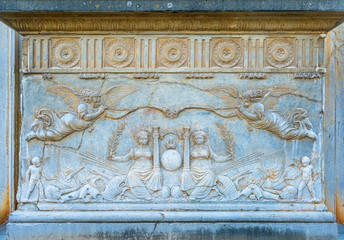 Fototapeta na wymiar Bas relief on the pedestal at the entrance of Palace of Charles V in the Alhambra Palace in Granada. Andalusia, Spain.
