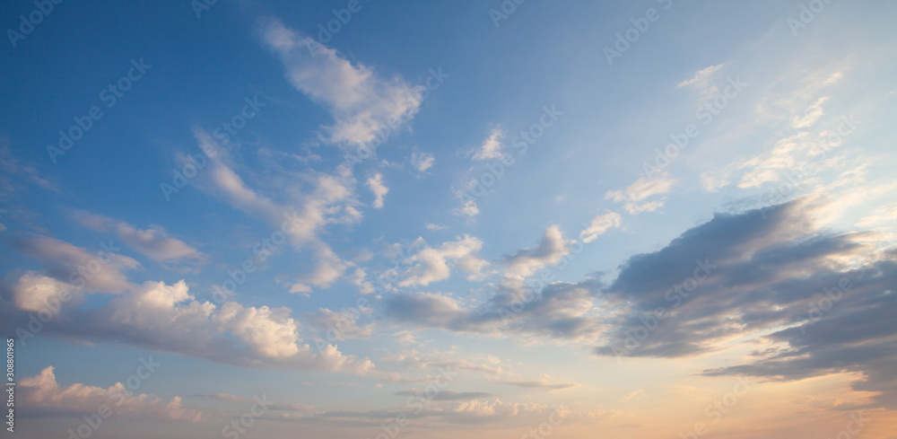 Wall mural blue sky clouds background. beautiful landscape with clouds and orange sun on sky