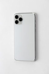 Smartphone with three cameras on a white background.