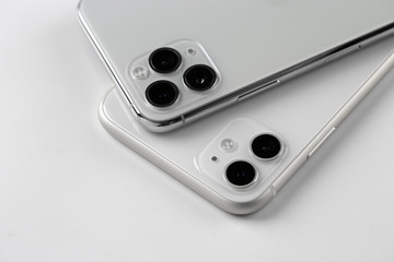 Two smartphones close-up on a white background.