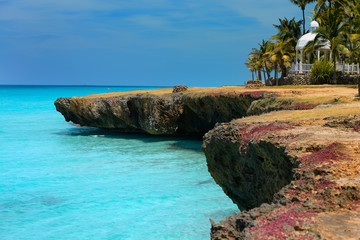 Lava rock shore with blow hole wells Palm trees and gazebo at Varadero Cuba resort