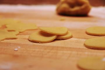 Pieces of the most tasty sweet in the world - Christmas cookies to golden brown. Compulsory gift for Santa Claus. Mum and child baking cookies. Biscuits for christmas eve. Concept of winter holidays