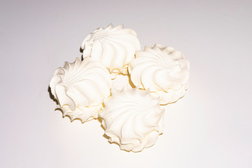 White marshmallows on a blue background. Copy space.