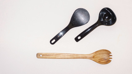 Wooden and plastic cutlery isolated on a white background. Flat lay with space for copy space. Set of cutlery for the designer.