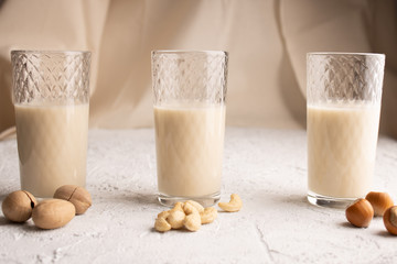 Three glasses with different types of organic milk. Nut milk without lactose, gmo, antibiotics and casein. Diet drink.