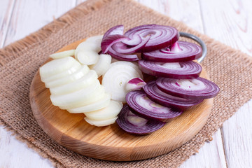 Sliced onion on a cutting board on a wooden table