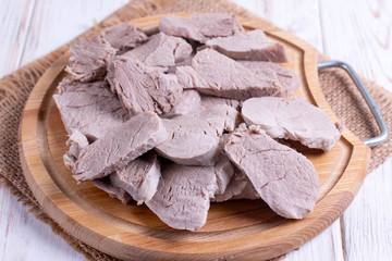 Sliced boiled meat, pork on a cutting board