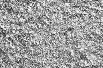 Crumpled silver foil as background, closeup view
