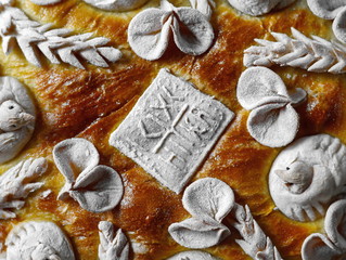 Homemade decorated Serbian slava bread with red wine.
