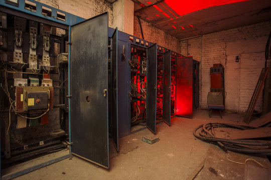 Switchgear cabinets with broken hardware in abandoned factory