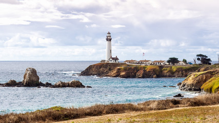 Panoramic view of the rocky shoreline close to the Pigeon Point Lighthouse on the Pacific Ocean coastline on a sunny day; Pescadero, San Francisco bay area, California