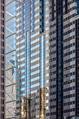 Fototapeta premium Urban abstract: window facade of a downtown office building with reflections and colors. Philadelphia, Pennsylvania.