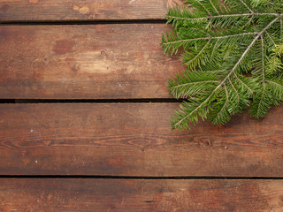 Spruce branches on old wooden boards. Christmas New Year's Eve concept. A look from above.