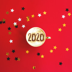 2020 year concept inscription on a cup of cappuccino on red.