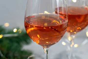 Orange wine is poured into two glasses. Celebratory drink. Family celebration.