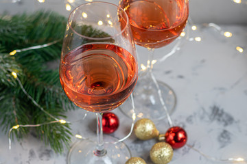 Orange wine is poured into two glasses. Celebratory drink. Family celebration.