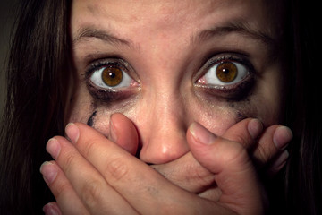crying girl with leaking mascara in horror closes her mouth with her hands. violence against women, Concept freedom of speech, censorship, freedom of press. International Human Right day.