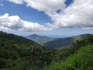 Naklejka premium Blue Mountain range with clouds in the sky. Interlocking hills