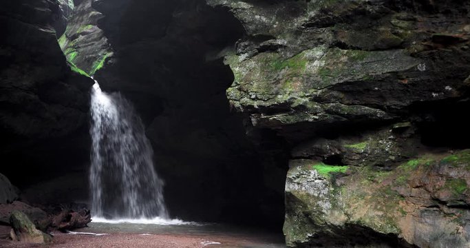 Dual waterfalls flow after heavy spring rains in a sandstone box canyon called Conkles Hollow in Hocking Hills State Park, Ohio. Seamlessly looping video footage.