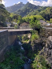 river running below a bridge with houses