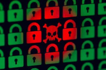 Skull and bone as a symbol of hacking programs or personal information and data. Cyber crime. Green pixel castles and a red skull with bones on a black background, close-up