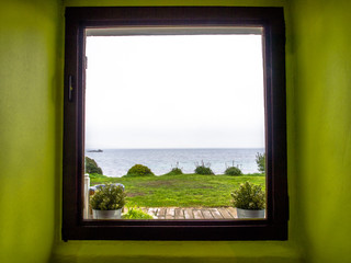Sea view from a window in a green room