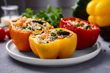Tasty stuffed bell peppers on grey table